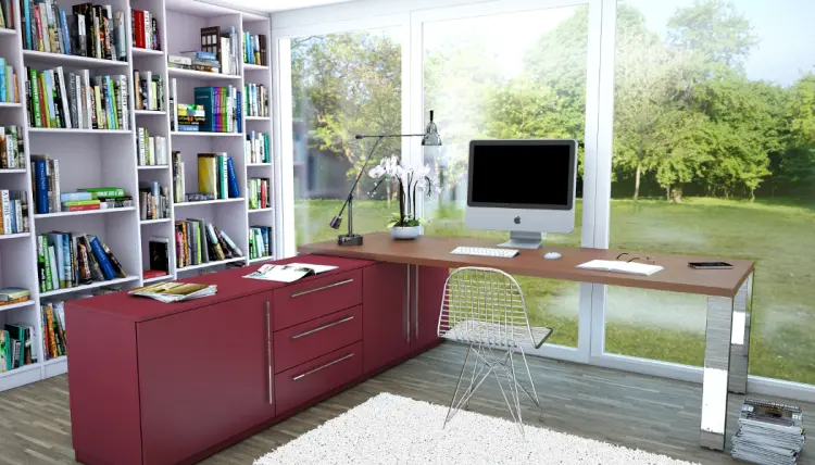 Weisse Buecherwand im Buero mit Schreibtisch und Sideboard in Rot.